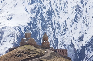14th century Gergeti Trinity Church (Georgian Orthodox) high in the mountains above 14th century Gergeti Trinity Church (Georgian Orthodox) high in the mountains above