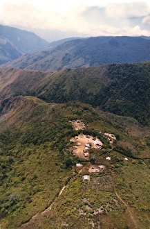 An aerial view of villagers congregating in the village square of a remote mountain An aerial view of villagers congregating in the village square of a remote mountain