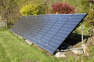 Array of solar PV photovolataic panels mounted on steel frame in field Array of solar PV photovolataic panels mounted on steel frame in field