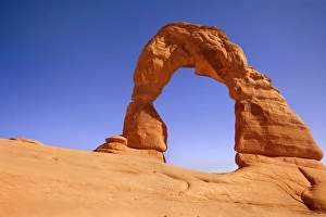 Delicate Arch - delicately sculptured sandstone arch standing on a slickrock slope Delicate Arch - delicately sculptured sandstone arch standing on a slickrock slope