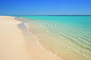 Dream Beach - white sandy beach, clear turquoise coloured water and a deep blue sky combine to a perfect beach. Through the clear water sand ripples, created by a gentle surf, are visible Dream Beach - white sandy beach, clear turquoise coloured water and a deep blue sky combine to a perfect beach. Through the clear water sand ripples, created by a gentle surf, are visible
