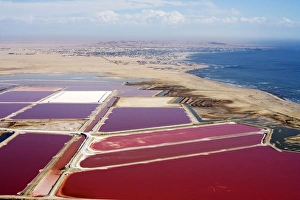 Evaporation ponds for the commercial extraction of sea salt - showing the bright Evaporation ponds for the commercial extraction of sea salt - showing the bright