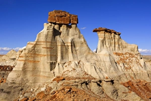 Hoodoos - eroded clay sculptures with rocks balanced on their tops located amidst badlands Hoodoos - eroded clay sculptures with rocks balanced on their tops located amidst badlands