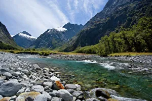 Mountain scenery - Hollyford river flowing down Hollyford valley surroundend by high Mountain scenery - Hollyford river flowing down Hollyford valley surroundend by high
