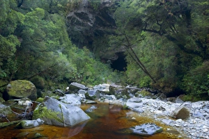 Oparara Arch - view of Oparara Arch and Oparara river when approached by foot from path Oparara Arch - view of Oparara Arch and Oparara river when approached by foot from path