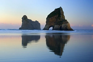 Rocky Islands - by powerful surf sculpted rock islands with caves and arches at Wharariki beach just before sunrise Rocky Islands - by powerful surf sculpted rock islands with caves and arches at Wharariki beach just before sunrise