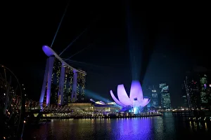 Singapore - Marine Bay sands and art science museum (right) night laser show Singapore - Marine Bay sands and art science museum (right) night laser show