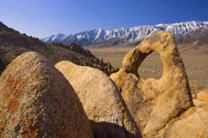 Whitney Portal Arch - rock arch of red granite with snow-capped mountains of the Sierra Whitney Portal Arch - rock arch of red granite with snow-capped mountains of the Sierra