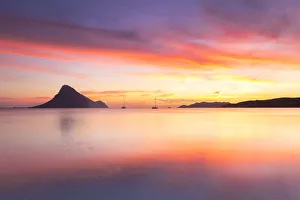 Amazing sunrise on the beach of Porto Taverna with the Tavolara Island in the background Amazing sunrise on the beach of Porto Taverna with the Tavolara Island in the background