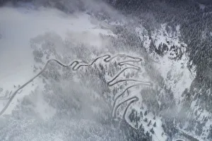 Fog on bends of Maloja Pass road and snowy woods, aerial view, Bregaglia Valley, Engadine Fog on bends of Maloja Pass road and snowy woods, aerial view, Bregaglia Valley, Engadine