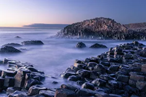 The Giant's Causeway rises out of the Atlantic late at night as the last light of The Giant's Causeway rises out of the Atlantic late at night as the last light of