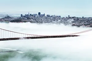 Golden Gate Bridge and the San Francisco skyline floating above the fog on a foggy day in Golden Gate Bridge and the San Francisco skyline floating above the fog on a foggy day in