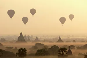 Hot air ballons fly over ancient temples at dawn in Bagan (Pagan), Myanmar (Burma), Asia Hot air ballons fly over ancient temples at dawn in Bagan (Pagan), Myanmar (Burma), Asia
