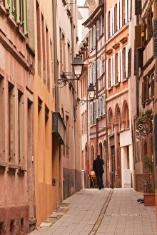 A man walks through La Petite France, Grande Ile, UNESCO World Heritage Site, Strasbourg A man walks through La Petite France, Grande Ile, UNESCO World Heritage Site, Strasbourg