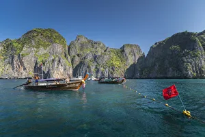 Maya Bay The Beach with long-tail boats and tourists, Phi Phi Lay Island, Krabi Province Maya Bay The Beach with long-tail boats and tourists, Phi Phi Lay Island, Krabi Province