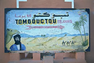 Painted road sign pointing in the direction of Tombouctou (Timbuktu) Painted road sign pointing in the direction of Tombouctou (Timbuktu)
