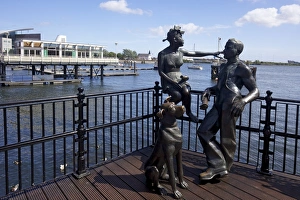 People Like Us, bronze sculpture of a young local couple with their dog People Like Us, bronze sculpture of a young local couple with their dog