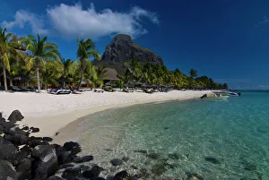 Sun loungers on the beach and Mont Brabant (Le Morne Brabant), UNESCO World Heritage Site Sun loungers on the beach and Mont Brabant (Le Morne Brabant), UNESCO World Heritage Site
