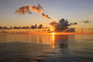 Sunset over beautiful calm sea, interesting clouds, vibrant colours, St. Kitts, St Sunset over beautiful calm sea, interesting clouds, vibrant colours, St. Kitts, St