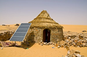 Traditional house with a solar panel in the Sahara Desert, Algeria, North Africa, Africa Traditional house with a solar panel in the Sahara Desert, Algeria, North Africa, Africa