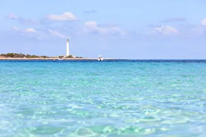 Turquoise sea with lighthouse in the background, San Vito Lo Capo, province of Trapani Turquoise sea with lighthouse in the background, San Vito Lo Capo, province of Trapani
