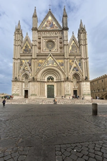 View of the facade of the Gothic cathedral with golden mosaics and bronze doors, Orvieto View of the facade of the Gothic cathedral with golden mosaics and bronze doors, Orvieto