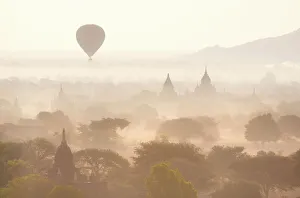 View over the temples of Bagan swathed in early morning mist, with hot air balloon drifting across the scene, from Shwesandaw Paya, Bagan, Myanmar (Burma), Southeast Asia View over the temples of Bagan swathed in early morning mist, with hot air balloon drifting across the scene, from Shwesandaw Paya, Bagan, Myanmar (Burma), Southeast Asia