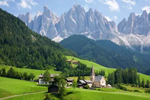 Village church and scattered farms beneath the Odle peaks in the Parco Naturale Puez-Odle Village church and scattered farms beneath the Odle peaks in the Parco Naturale Puez-Odle