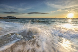 Waves crashing on the sandy beach framed by sunrise, Porto Recanati, Province of Macerata Waves crashing on the sandy beach framed by sunrise, Porto Recanati, Province of Macerata
