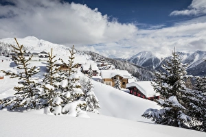 The winter sun shines on the snowy mountain huts and woods, Bettmeralp, district of Raron The winter sun shines on the snowy mountain huts and woods, Bettmeralp, district of Raron