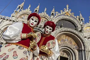 Two girls dressed as Russian dolls stand in front of the Basilica in St Two girls dressed as Russian dolls stand in front of the Basilica in St
