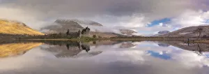 The ruins of Kilchurn Castle reflected in Loch Awe at dawn on a misty morning in the The ruins of Kilchurn Castle reflected in Loch Awe at dawn on a misty morning in the