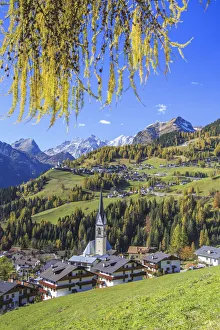 Yellow larches color the villages of Selva of Cadore and Saint Lucia hill in autumn Yellow larches color the villages of Selva of Cadore and Saint Lucia hill in autumn