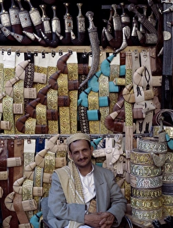 Yemeni trader sells traditional daggers at his stall Yemeni trader sells traditional daggers at his stall