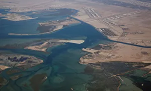 An aerial view of Arabian Gulf with city of Abu Dhabi is pictured through the window of An aerial view of Arabian Gulf with city of Abu Dhabi is pictured through the window of