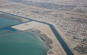 An aerial view of Arabian Gulf with city of Abu Dhabi is pictured through the window of An aerial view of Arabian Gulf with city of Abu Dhabi is pictured through the window of