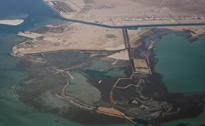 An aerial view of Arabian Gulf with city of Abu Dhabi is pictured through the window of An aerial view of Arabian Gulf with city of Abu Dhabi is pictured through the window of