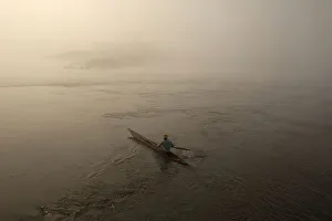A fisherman paddles his boat on the river Oubangui in Bangui A fisherman paddles his boat on the river Oubangui in Bangui