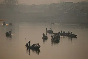 Kashmiri boatmen extract sand from the Jhelum river on a cold winter morning in Srinagar Kashmiri boatmen extract sand from the Jhelum river on a cold winter morning in Srinagar