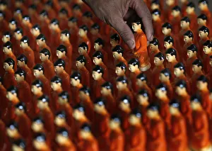 A man packs statues of Buddha at a workshop ahead of Vesak Day celebrations in Colombo A man packs statues of Buddha at a workshop ahead of Vesak Day celebrations in Colombo