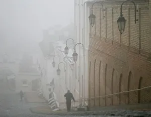 A man walks in fog in the territory of the Kiev Pechersk Lavra monastery in Kiev A man walks in fog in the territory of the Kiev Pechersk Lavra monastery in Kiev