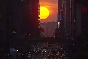 People take pictures of sunset on 42nd street, during the Manhattanhenge in New York People take pictures of sunset on 42nd street, during the Manhattanhenge in New York