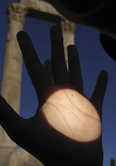 Planet Venus is seen as a black dot on a man's hand as it makes its transit across the Planet Venus is seen as a black dot on a man's hand as it makes its transit across the