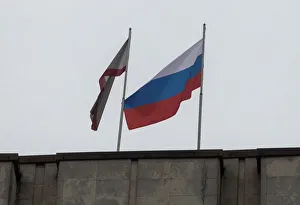 A Russian flag is raised next to a Crimean flag on top of the Crimean parliament building A Russian flag is raised next to a Crimean flag on top of the Crimean parliament building