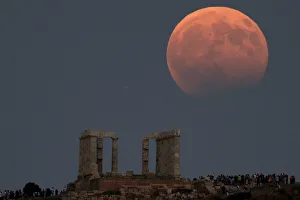 Temple of Poseidon is seen as the moon is partially covered by the Earths shadow during Temple of Poseidon is seen as the moon is partially covered by the Earths shadow during