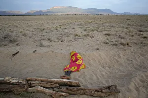 A Turkana man sleeps on the western shore of Lake Turkana close to Todonyang near the A Turkana man sleeps on the western shore of Lake Turkana close to Todonyang near the