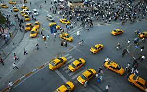 Yellow taxis pass people standing in silence during a protest at Taksim Square Yellow taxis pass people standing in silence during a protest at Taksim Square