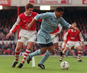 Coventry's John Salako holds off Adrian Clark during Premiership match at Highbury Coventry's John Salako holds off Adrian Clark during Premiership match at Highbury