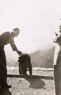 BEAR CUB, c1942. Man petting a bear cub, possibly at Great Smoky Mountains National Park BEAR CUB, c1942. Man petting a bear cub, possibly at Great Smoky Mountains National Park