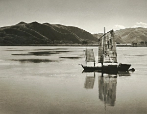 CHINA: SAILBOAT. A sailboat on a river in the Kiangsu or Yunnan Province in China CHINA: SAILBOAT. A sailboat on a river in the Kiangsu or Yunnan Province in China